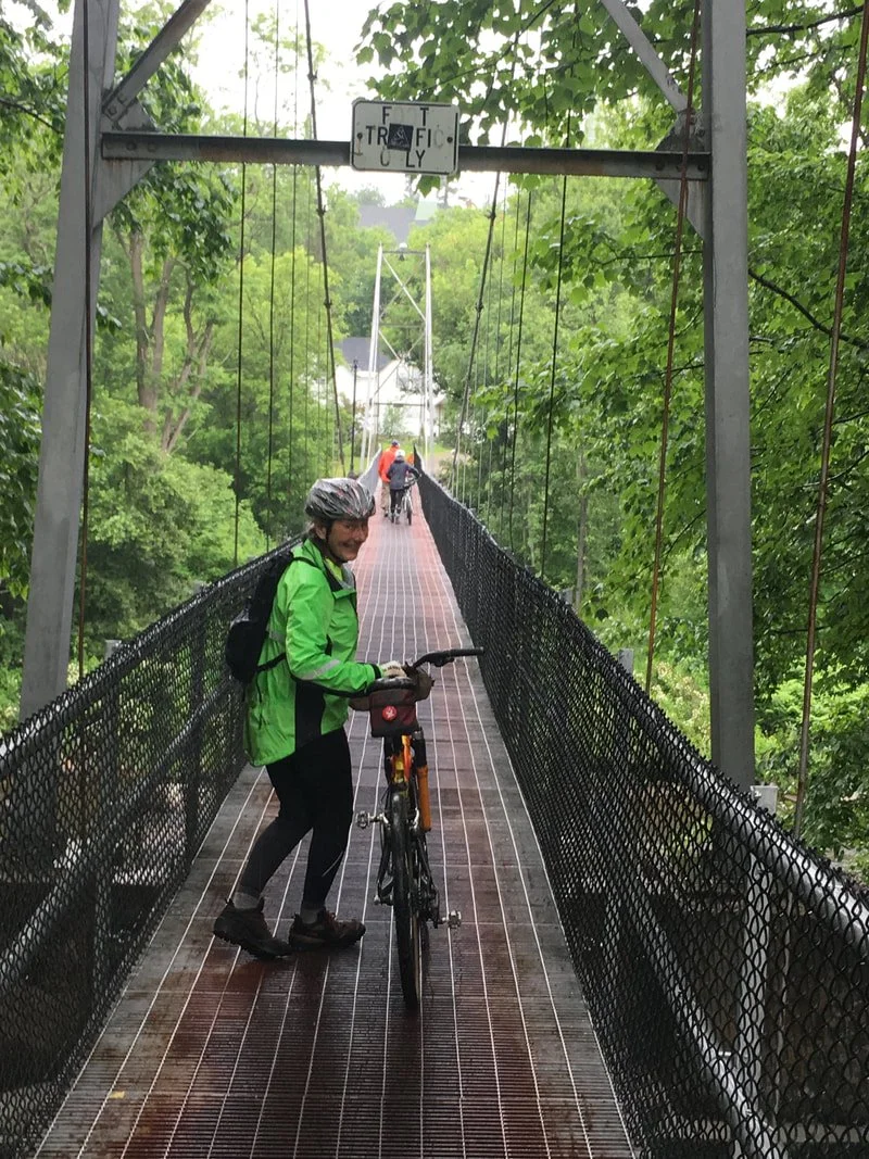 A suspension bridge over the Ammonoosuc River leads to Main Street in the town of Littleton