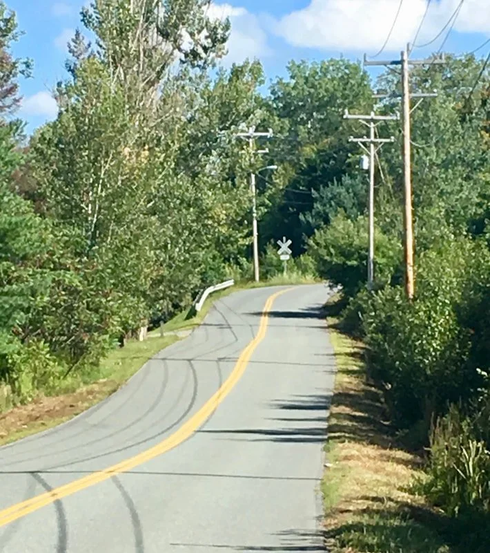 Up ahead on the left, before the hill and the guard rail, is the entrance to the Littleton Bikeway