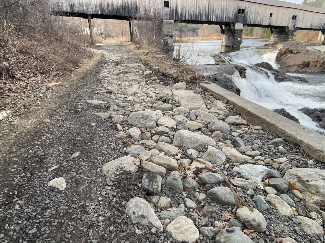Before: In April 2024, the river did a good job of taking out the trail at the Bath Covered Bridge.