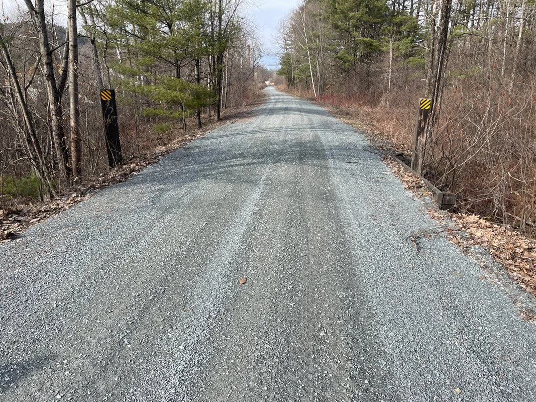 But Wait...What's this? More restorative work on the Ammonoosuc Rail Trail in Lisbon! This is what quality ditching, grading, crowning and a new surface can do for keeping water running AWAY from the rail trail! This is an experiment to test a new su