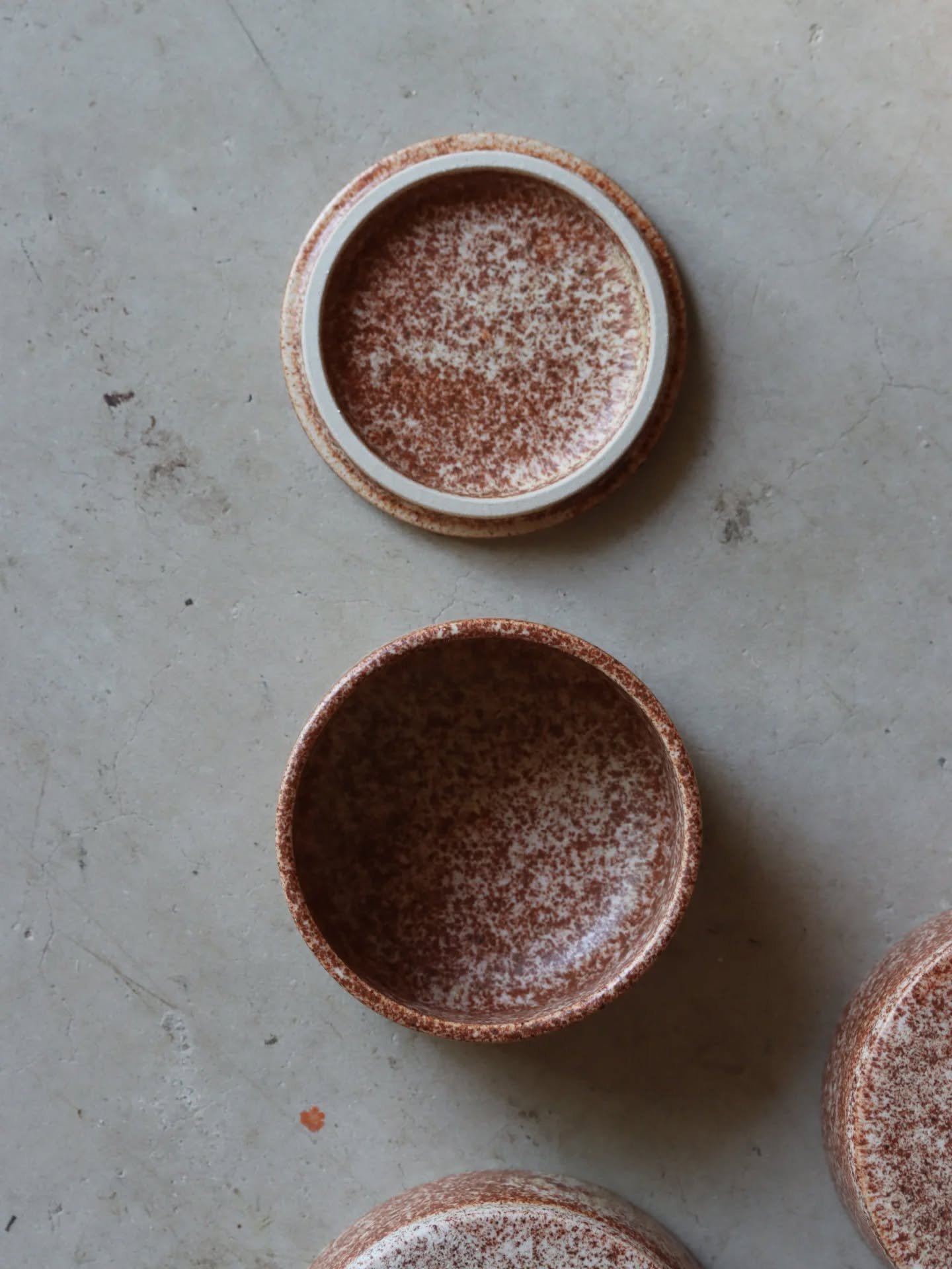 Lidded boxes in speckled glaze.
