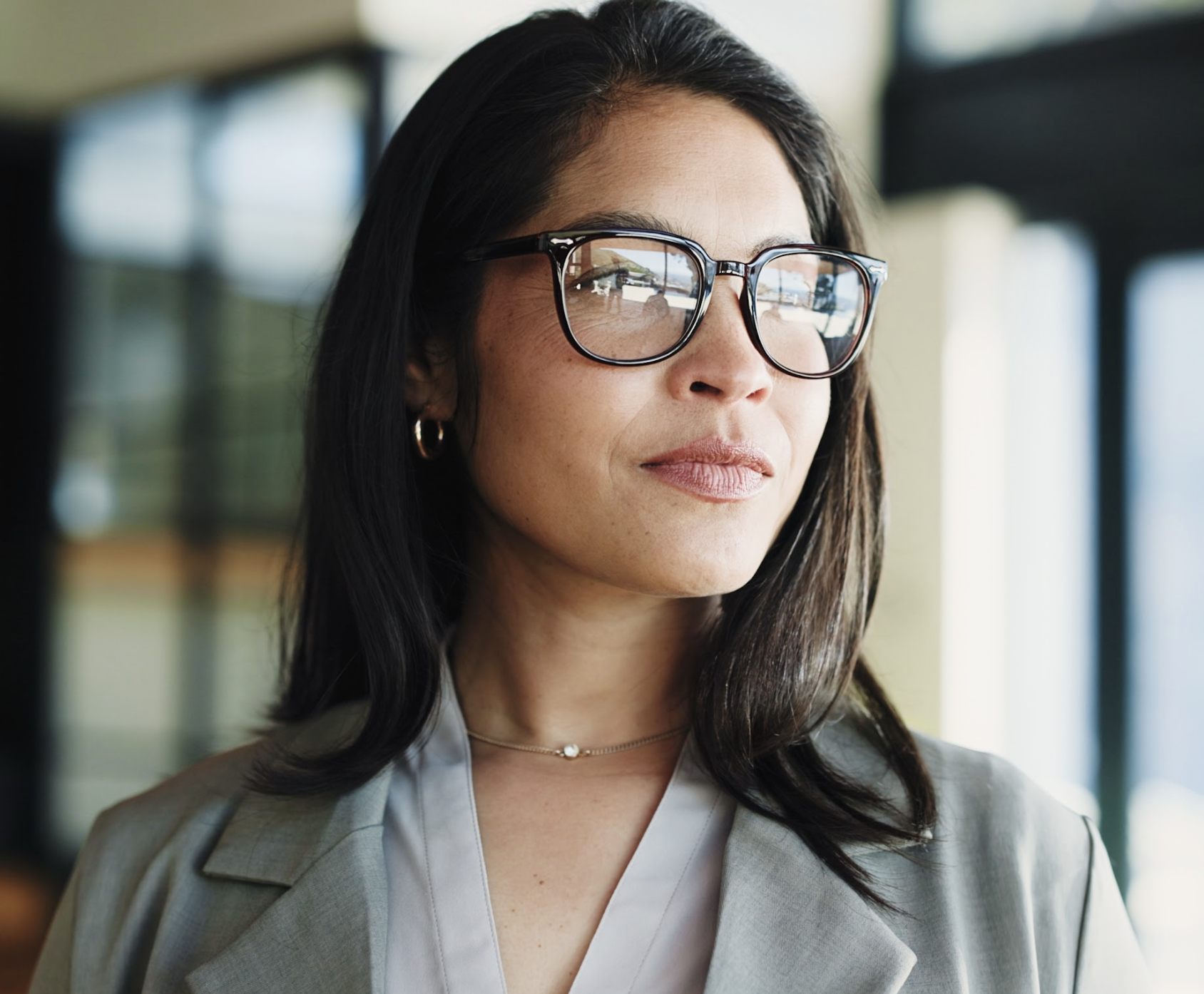 Professional woman with glasses thinking