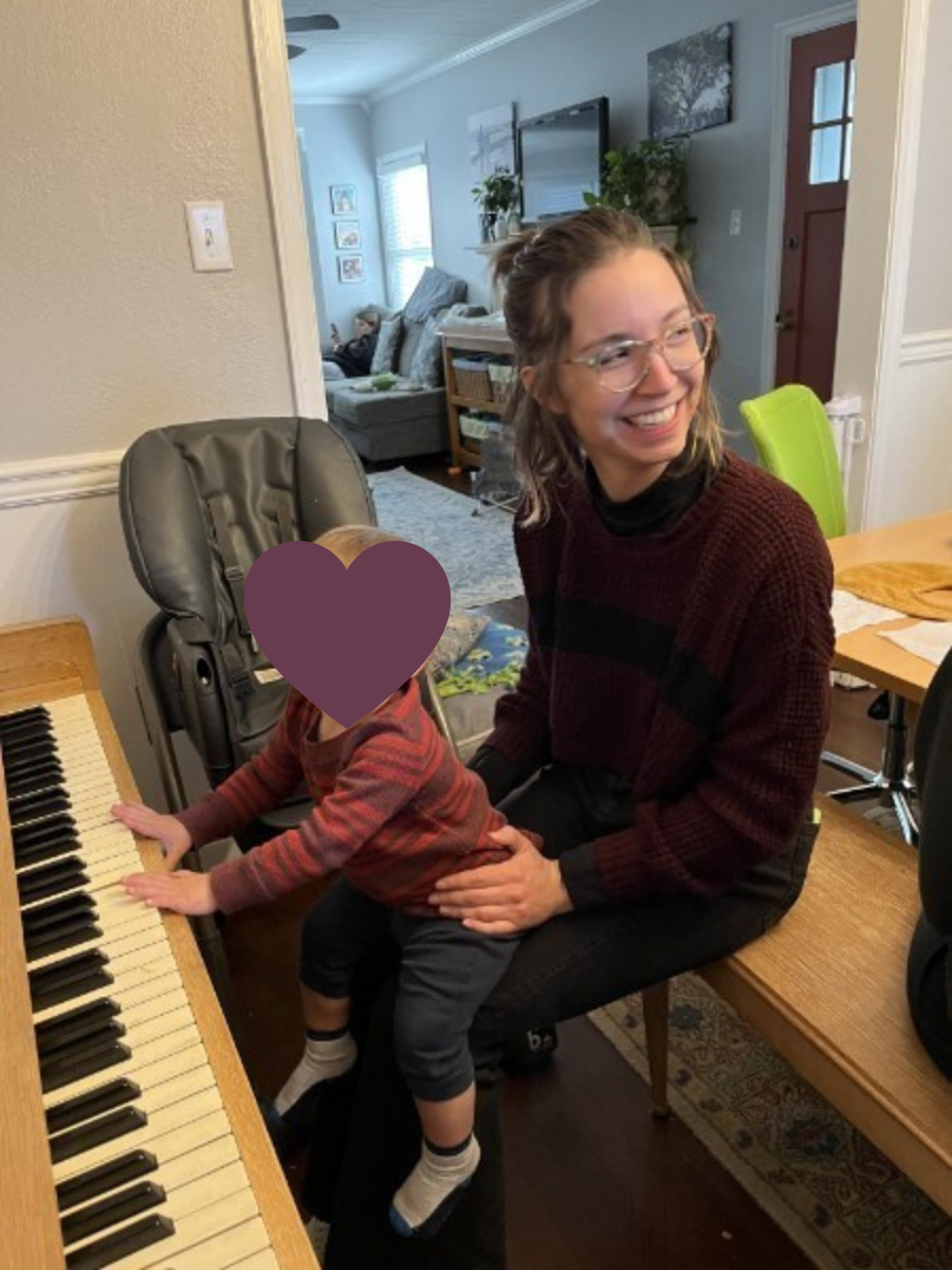 ab-seated-at-piano-bench-smiling-with-toddler-on-her-lap-who-is-plunking-on-piano-keys