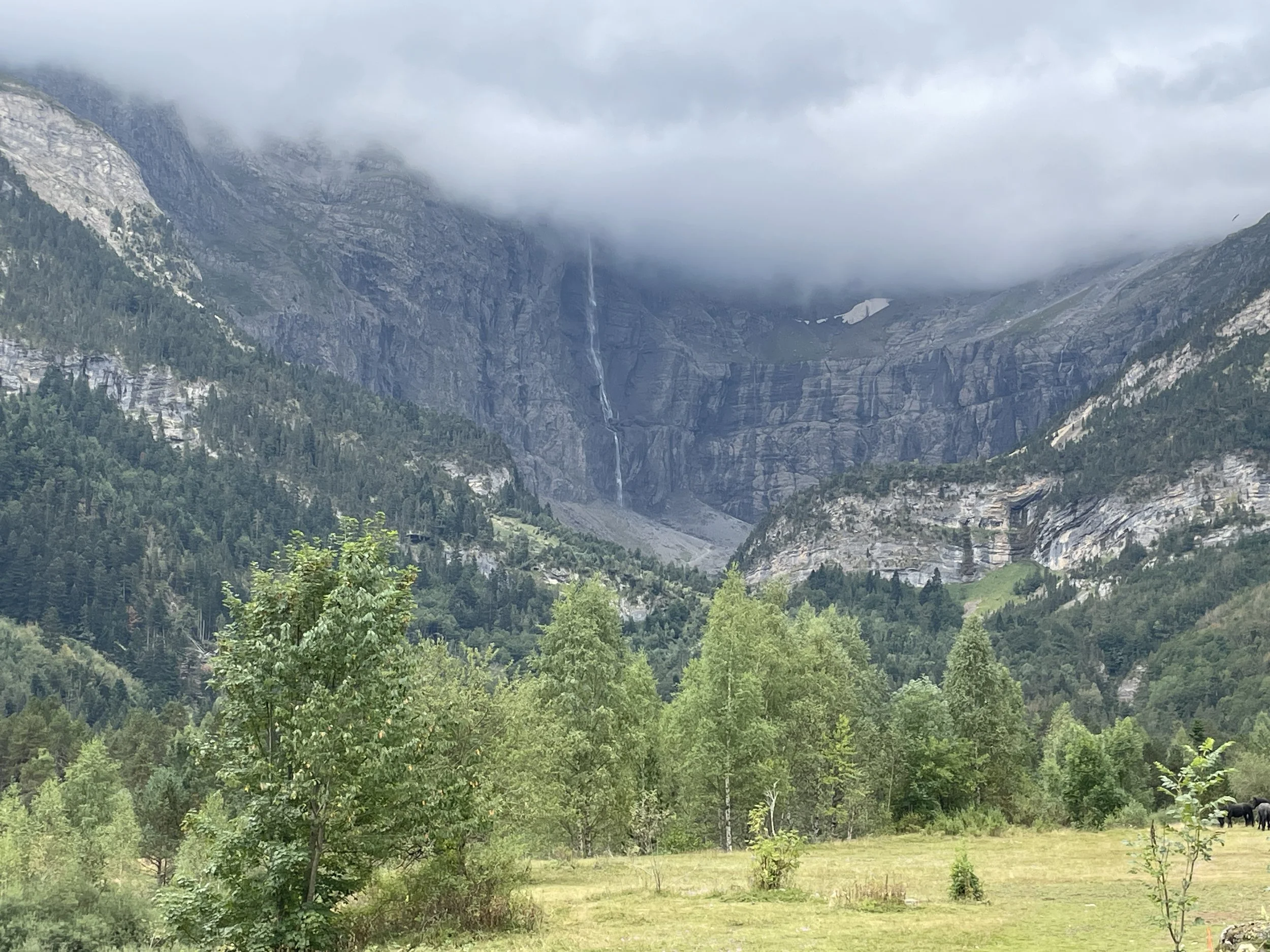 The Cirque de Gavernie with a bit of cloud cover, but you can still see the impressive waterfall and some leftover snow from the previous winter.