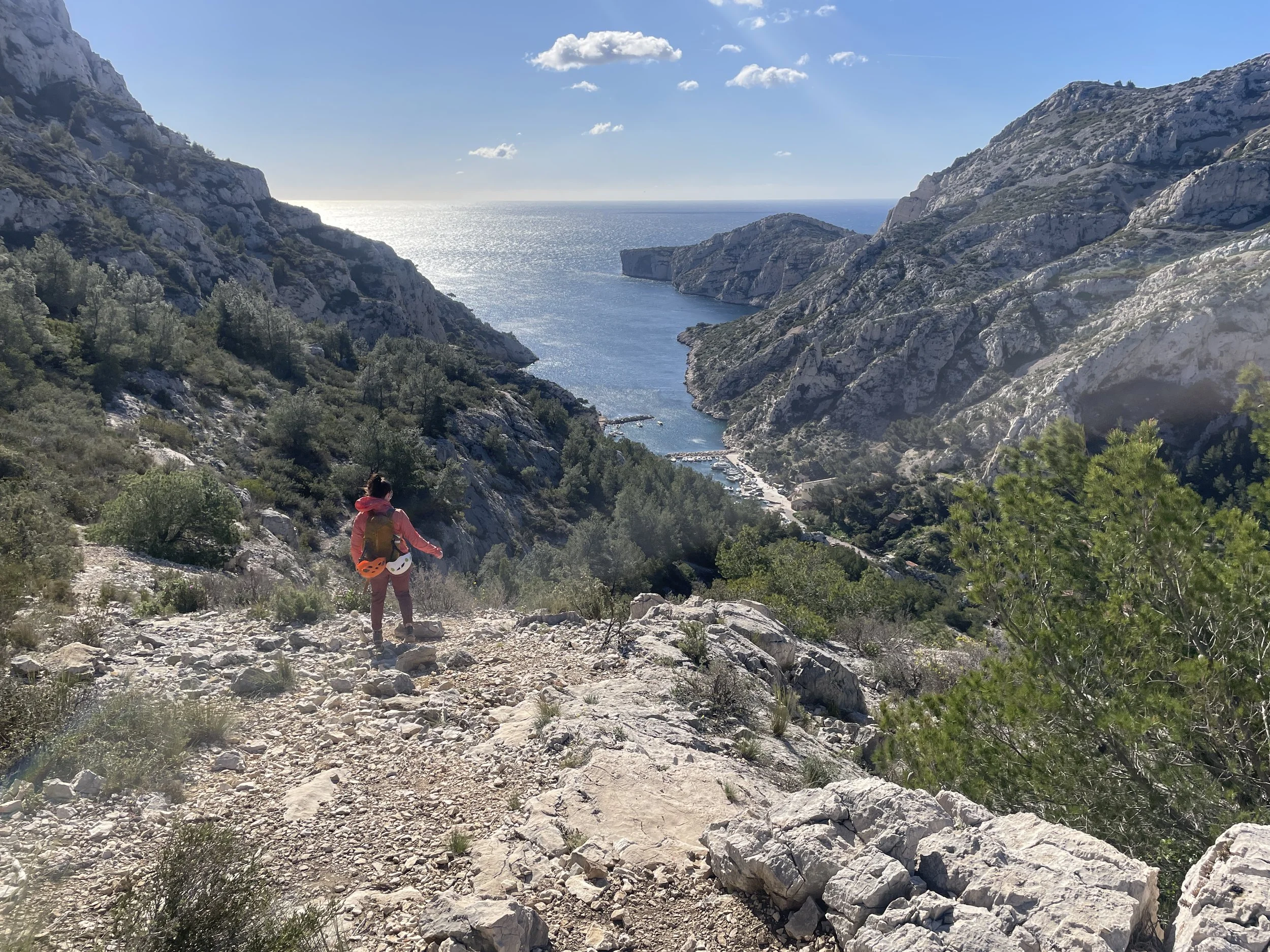 Leslie, the owner of Sensorie, hiking out of a multipitch climb overlooking Calanque de Morgiou, France.