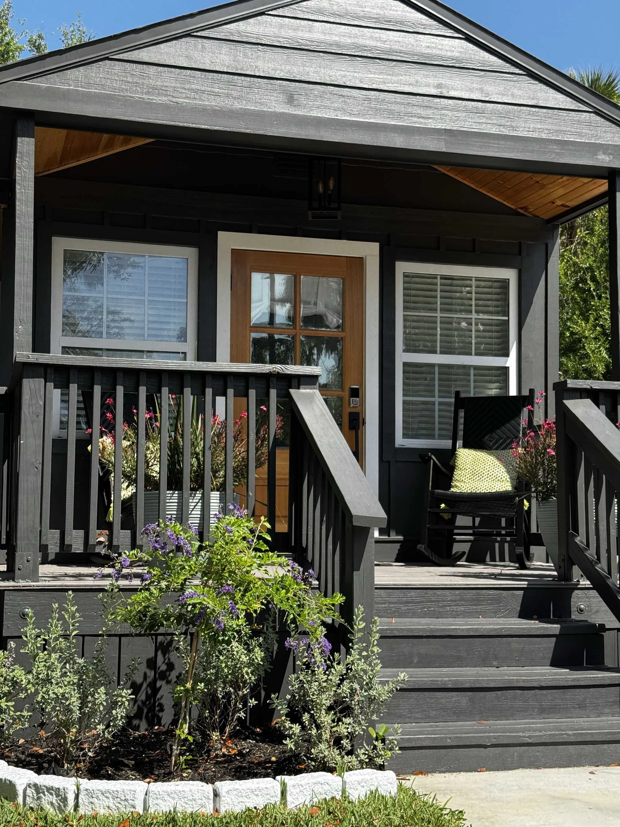 Rustic cottage painted black with wooden door