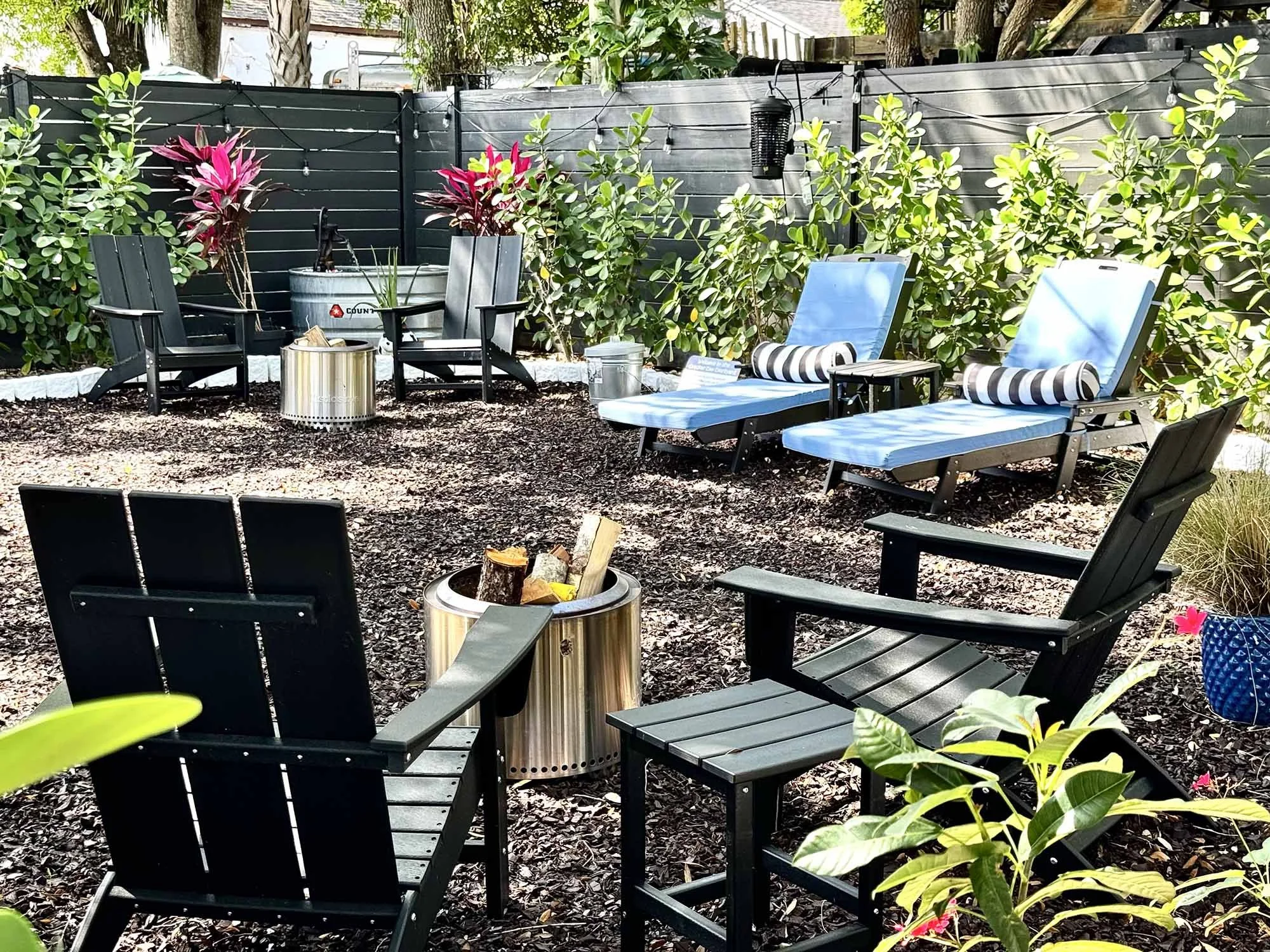 Outdoor courtyard with fire pit and lounge chairs