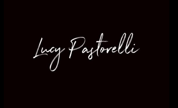 The image displays the name 'Lucy Pastorelli' written in white cursive font on a black background.