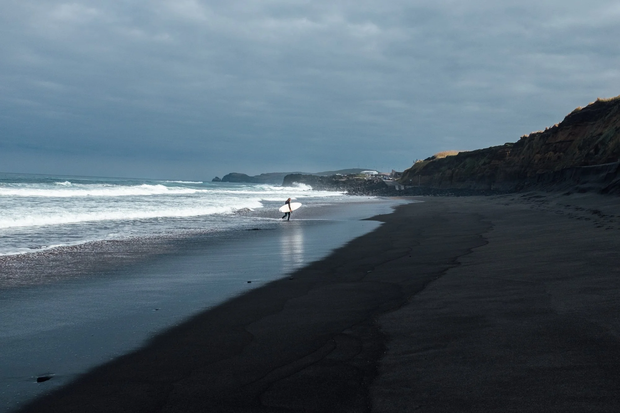 Praia do Areal de Santa Bárbara. Black-sand with rolling Atlantic waves, popular with surfers.