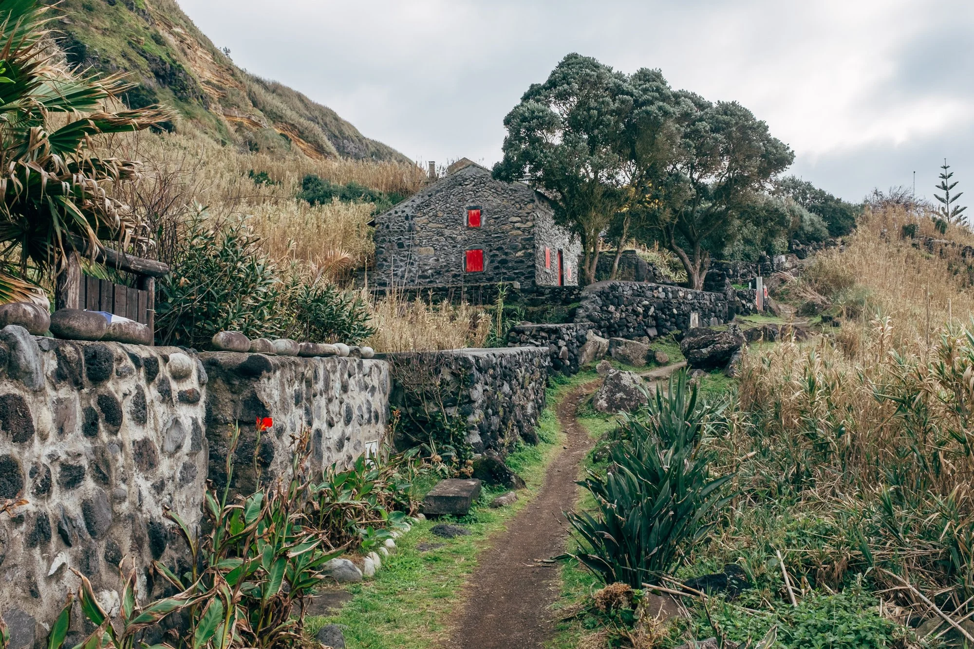 Rocha da Relva is accessible primarily by foot, donkey, and dirt bike. Every year on August 15, locals hold a religious festival and Mass celebrating the Feast of the Assumption.