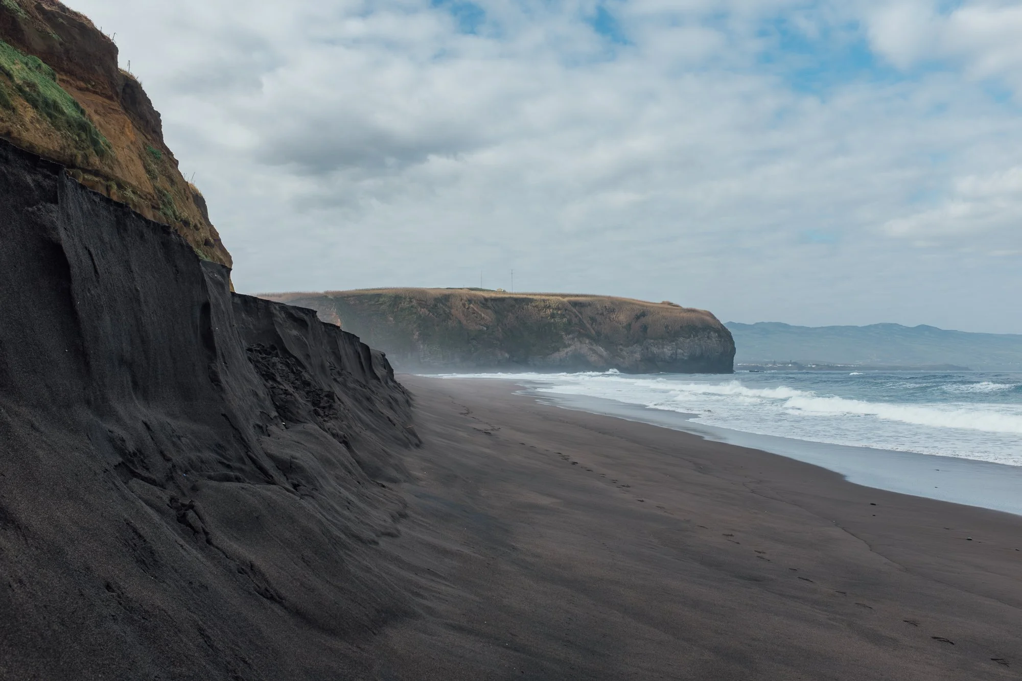 Praia do Areal de Santa Bárbara. Black-sand with rolling Atlantic waves, popular with surfers.