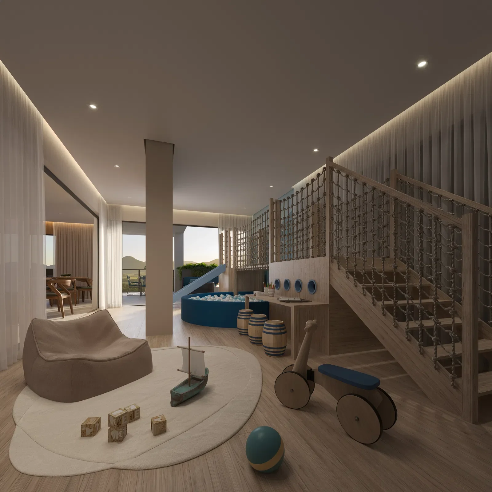 Sala de brinquedos infantil com escorregador azul, piscina de bolinhas, balanço de madeira estilo trenzinho, almofada grande, tapete oval branco, brinquedos de blocos de madeira, decorada com cortinas brancas e janelas que deixam a luz natural entrar