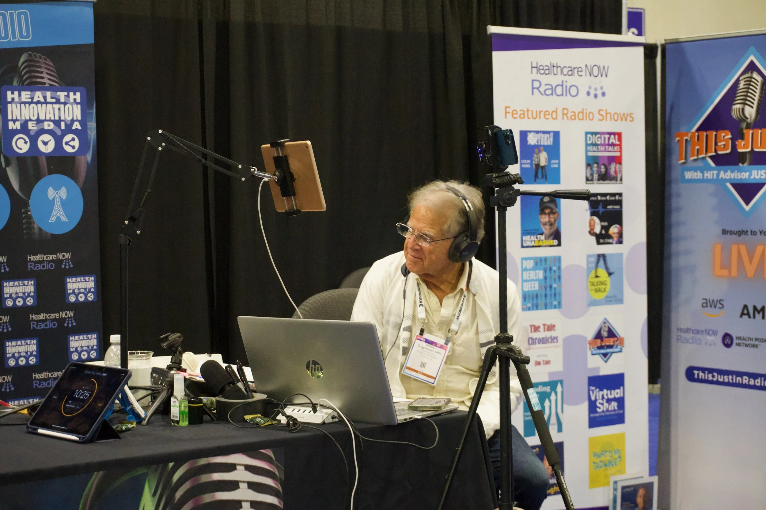 Gregg Masters working the audio at a healthcare radio broadcast booth at HIMSS.
