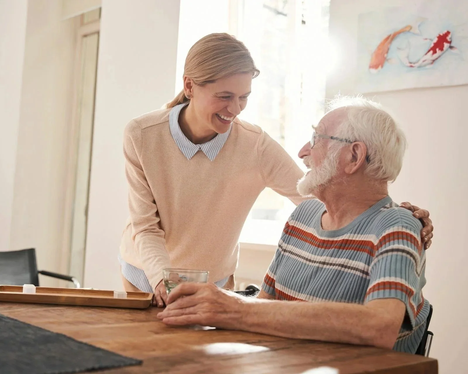 caregiver with older adult male patient in home
