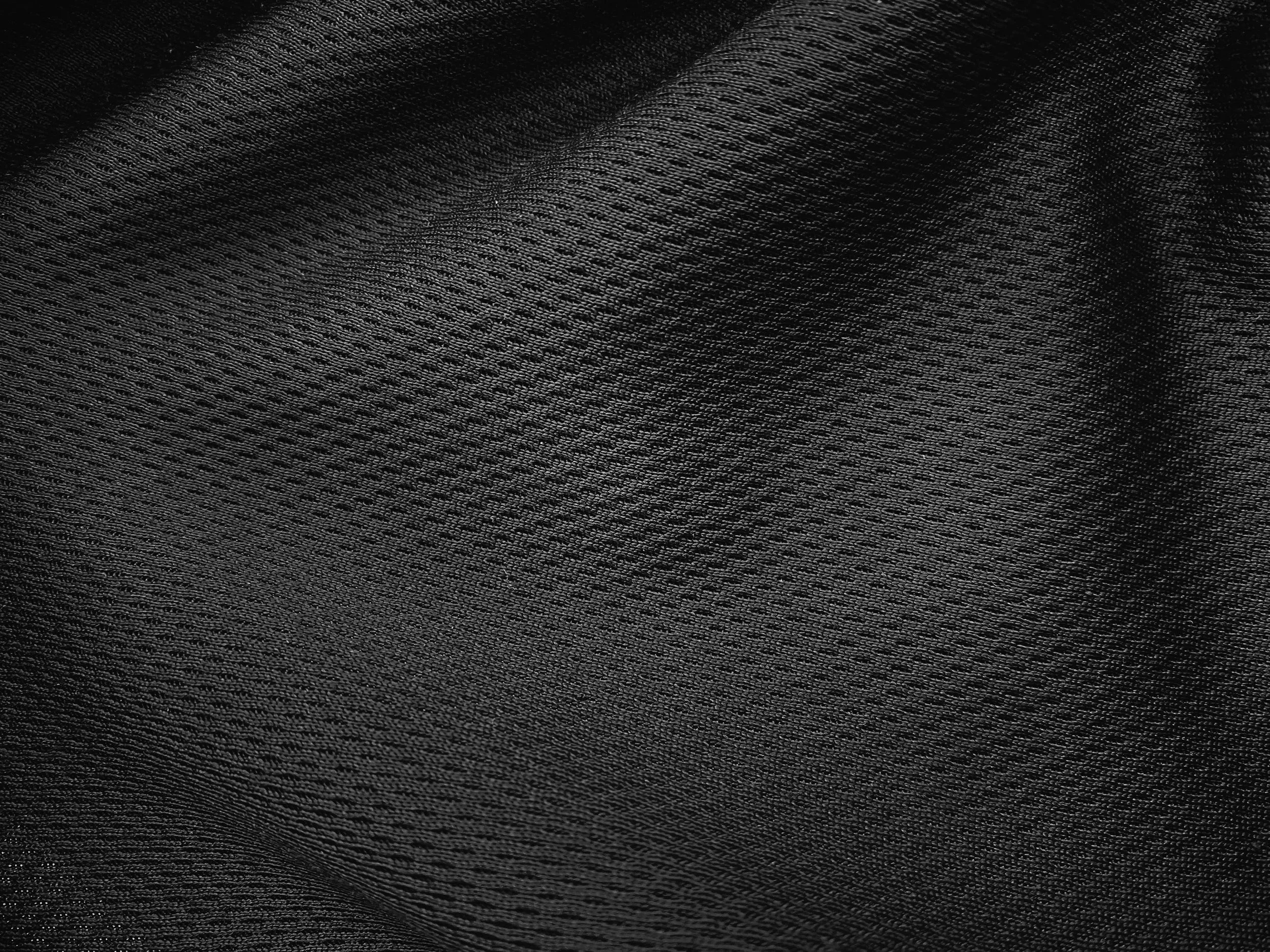 Close-up of black textured fabric with a woven pattern.