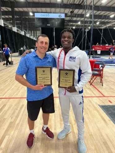 Boys Team Gymnast Fred and Head Coach Levon honored at Nationals
