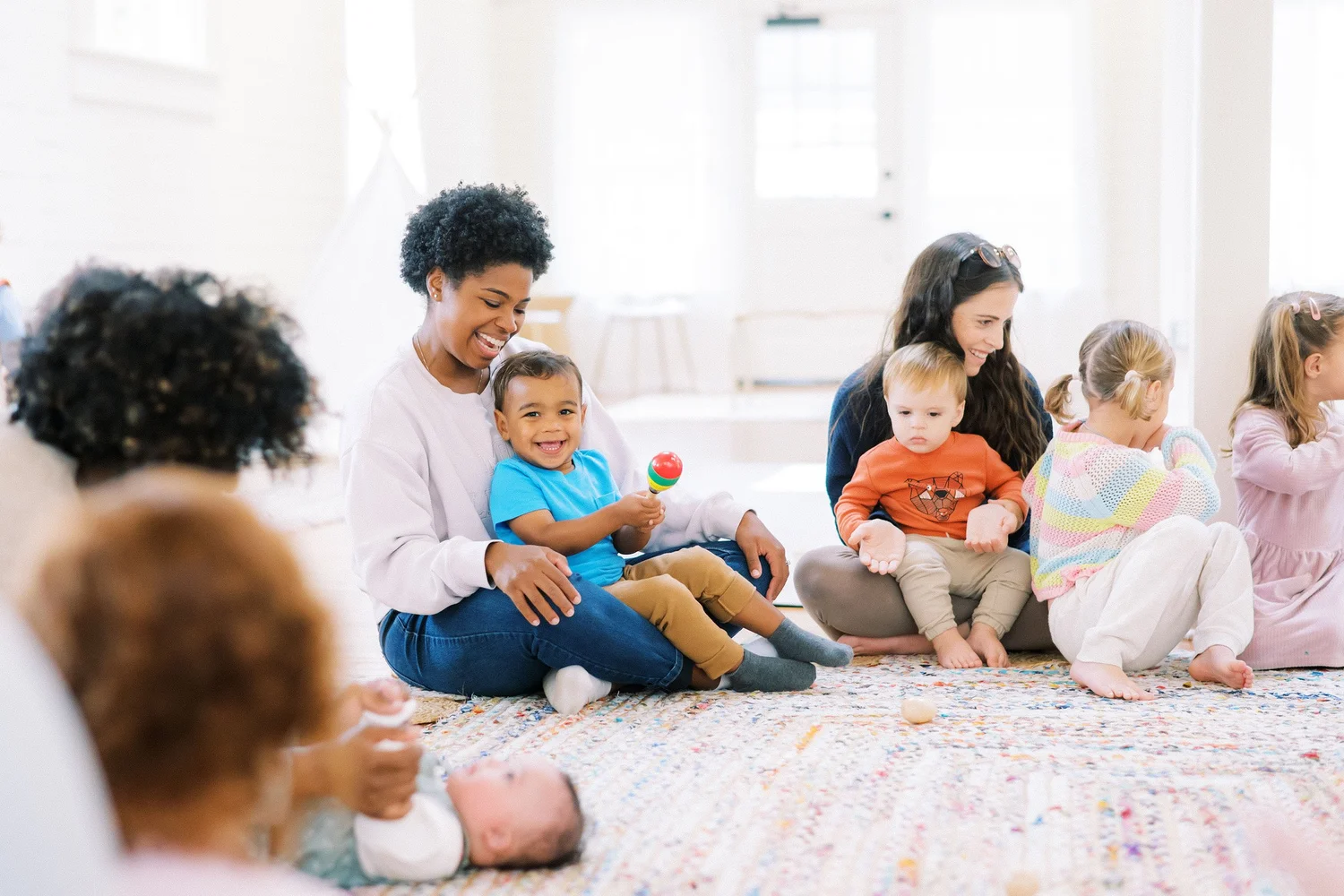 Families gathered on the rug at The Reverie