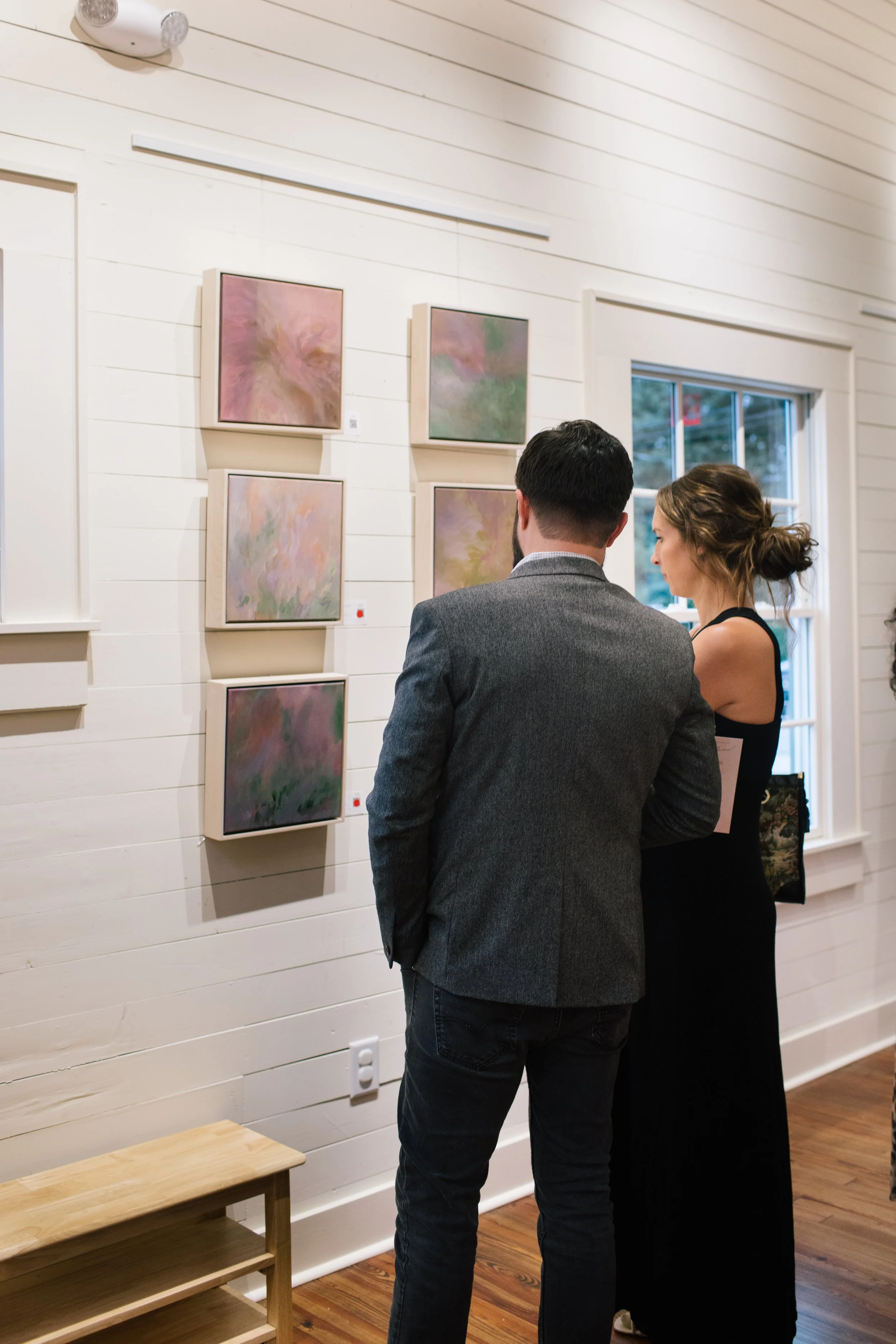 Couple viewing artwork inside The Reverie event space in Winston-Salem, NC.