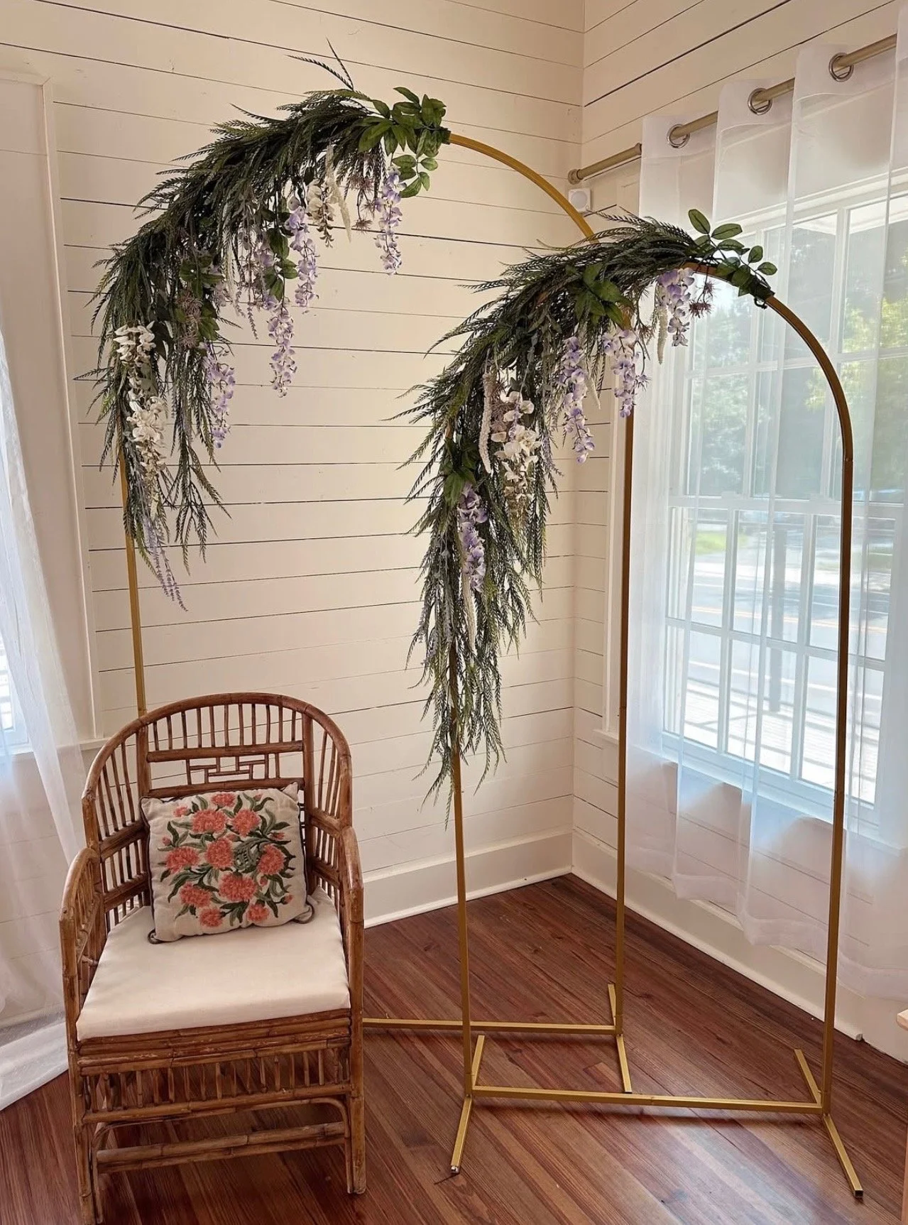Floral arch setup inside The Reverie, a Winston-Salem event venue available for showers, birthdays, and community gatherings.