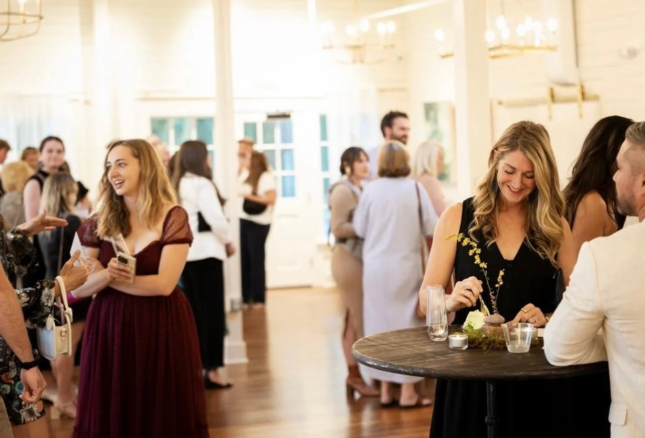 Moms socializing at a Mom League daytime event in Winston-Salem, connecting in a bright, welcoming community space.