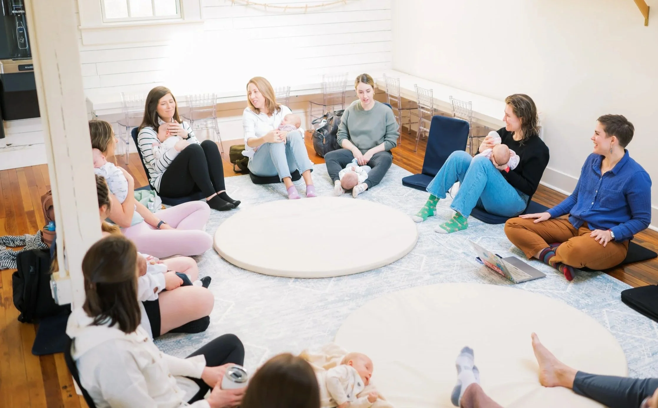 Moms sitting in a circle with babies during a Mom League playgroup in Winston-Salem, NC.