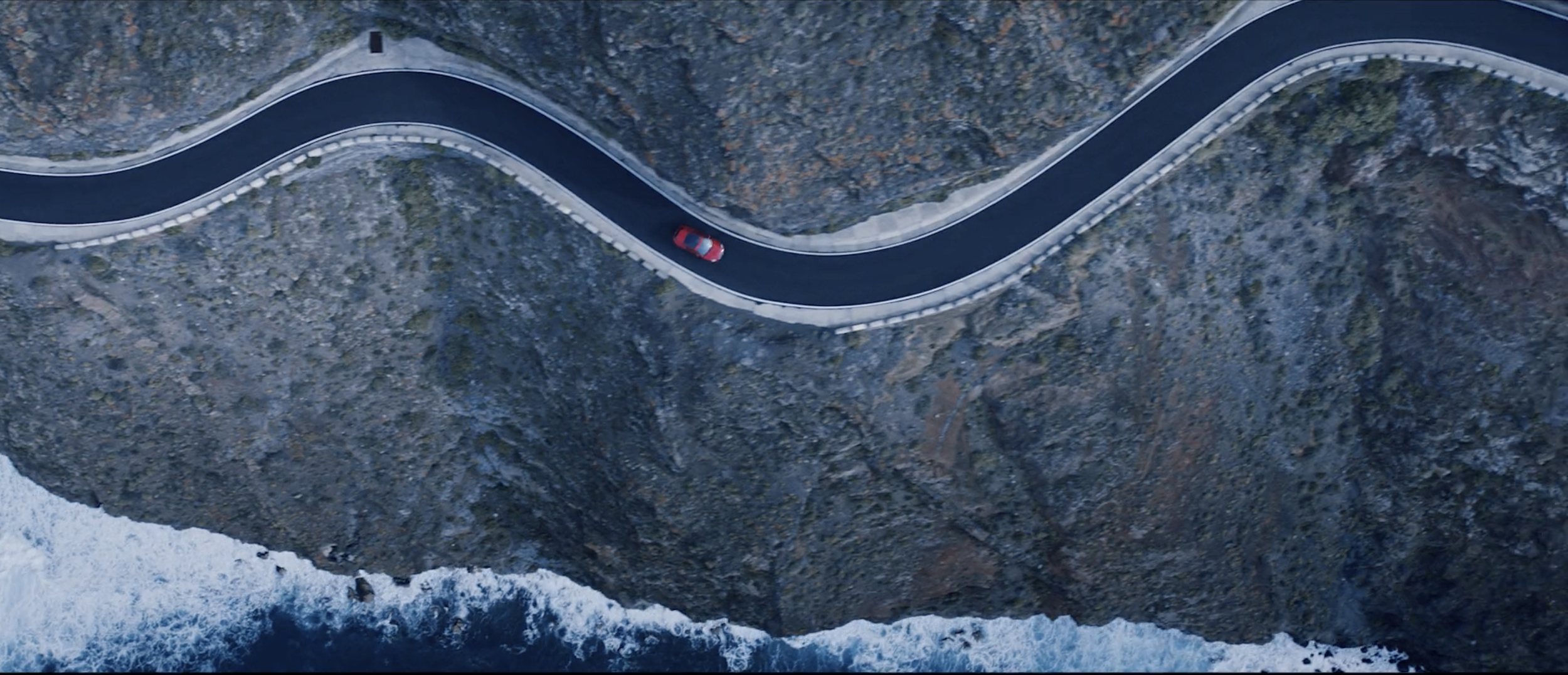 Overhead image of a red Jaguar E-PACE in a commercial filmed on location in Tenerife by cinematographer Callan Green ACS NZCS