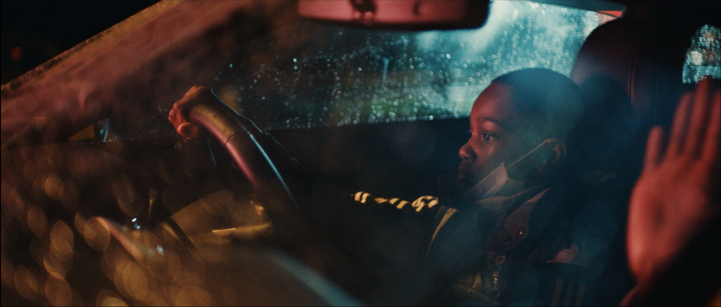 Stylish image OF A YOUNG BOY DRIVING A CAR from Just Banco’s ‘Ashleigh’ music video, filmed on location in Manchester by cinematographer Callan Green ACS NZCS