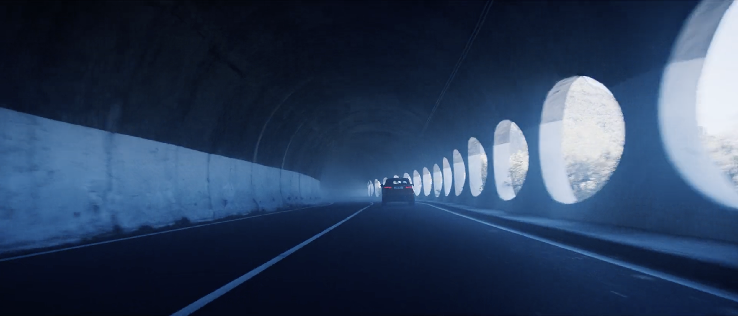 Stylish image of a red Jaguar E-PACE driving through a tunnel in a commercial filmed on location in Tenerife by cinematographer Callan Green ACS NZCS