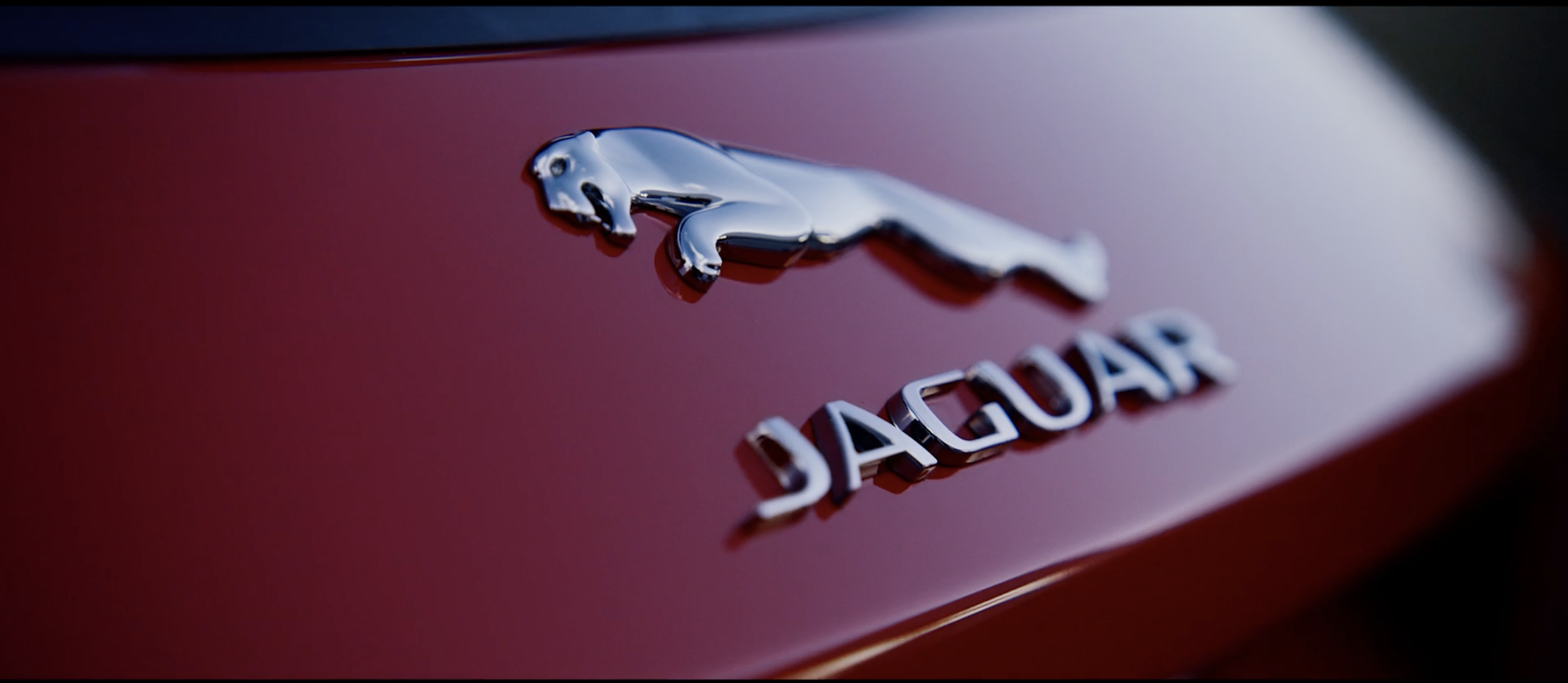 Stylish image of a red Jaguar badge in a commercial filmed on location in Tenerife by cinematographer Callan Green ACS NZCS