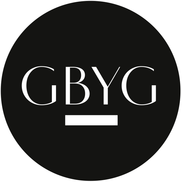 A black circular logo with the letters 'GBYG' in the center and a underline below, all in black.