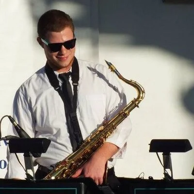Professional saxophonist performing with DJ at an upscale wedding as part of Luxe Entertainment’s hybrid band experience.