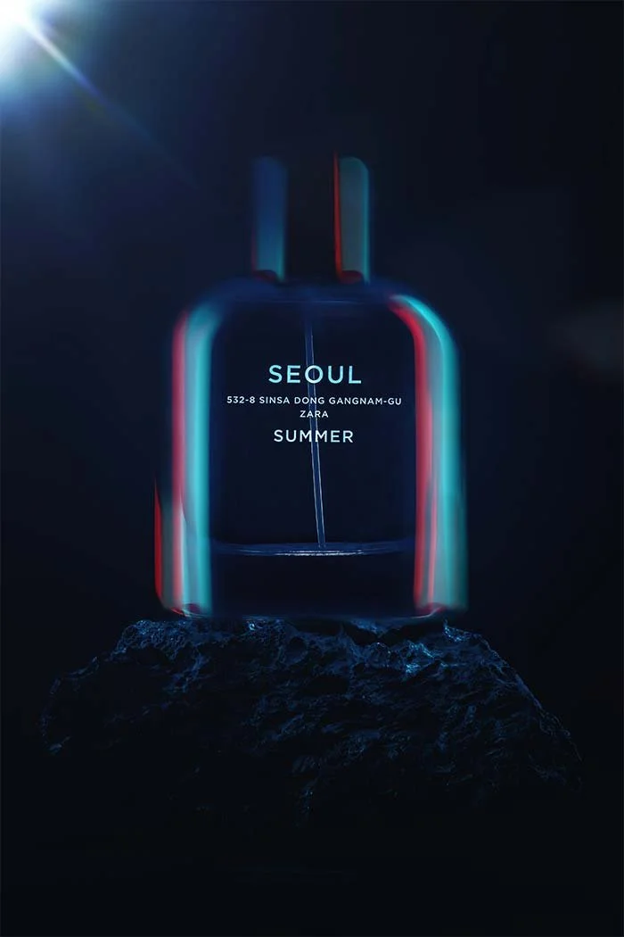 Une bouteille de parfum suspendue au-dessus d'une roche, avec un éclairage néon bleu et rouge, émettant une lueur dans l'obscurité.