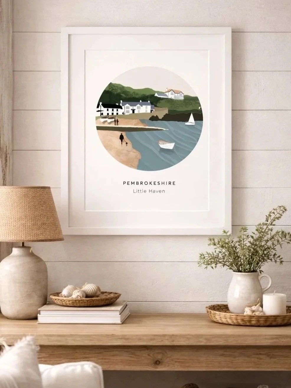 A selection of Pembrokeshire Printscape coastal prints displayed in a cosy neutral interior.