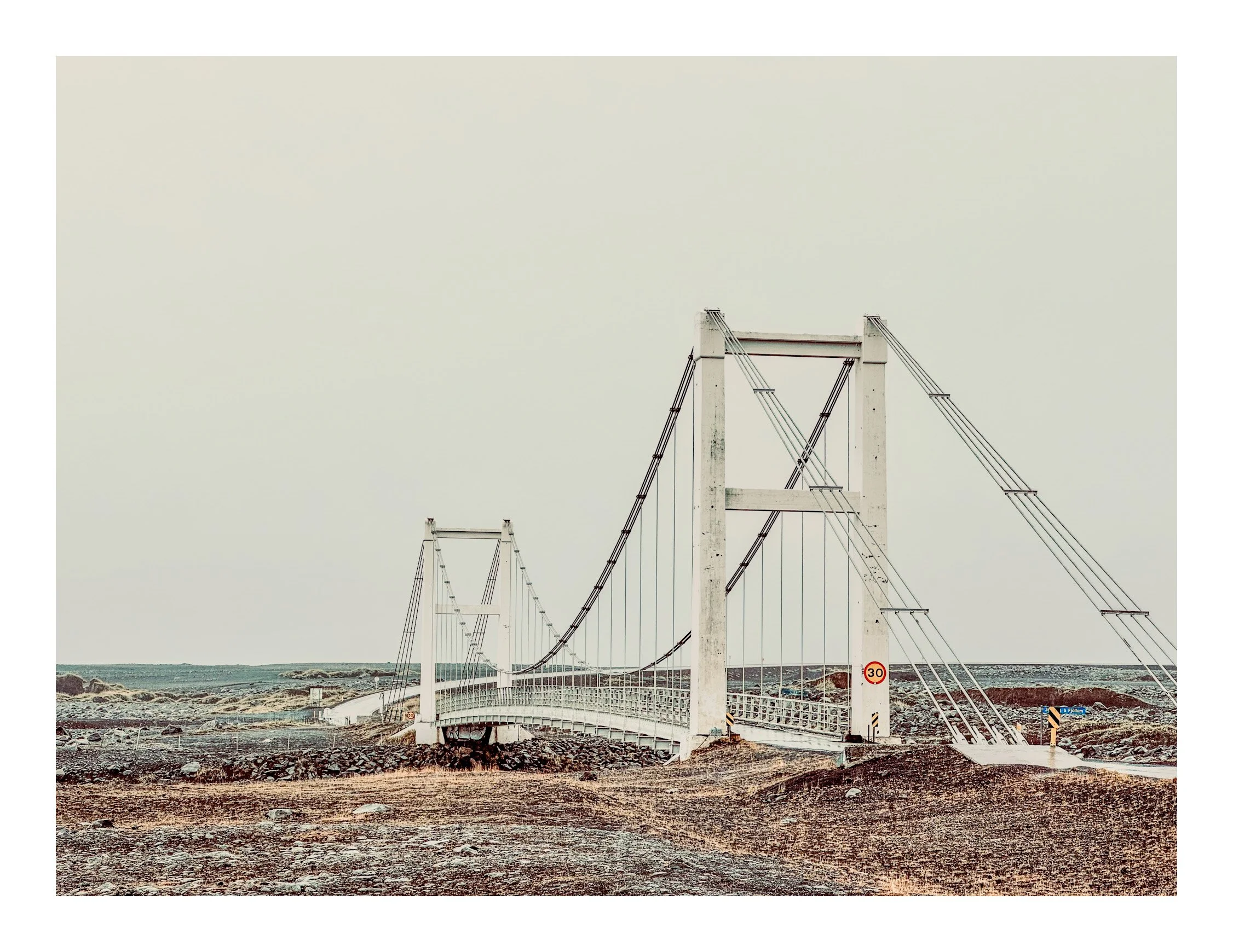 Empty suspension bridge over rocky terrain with a 