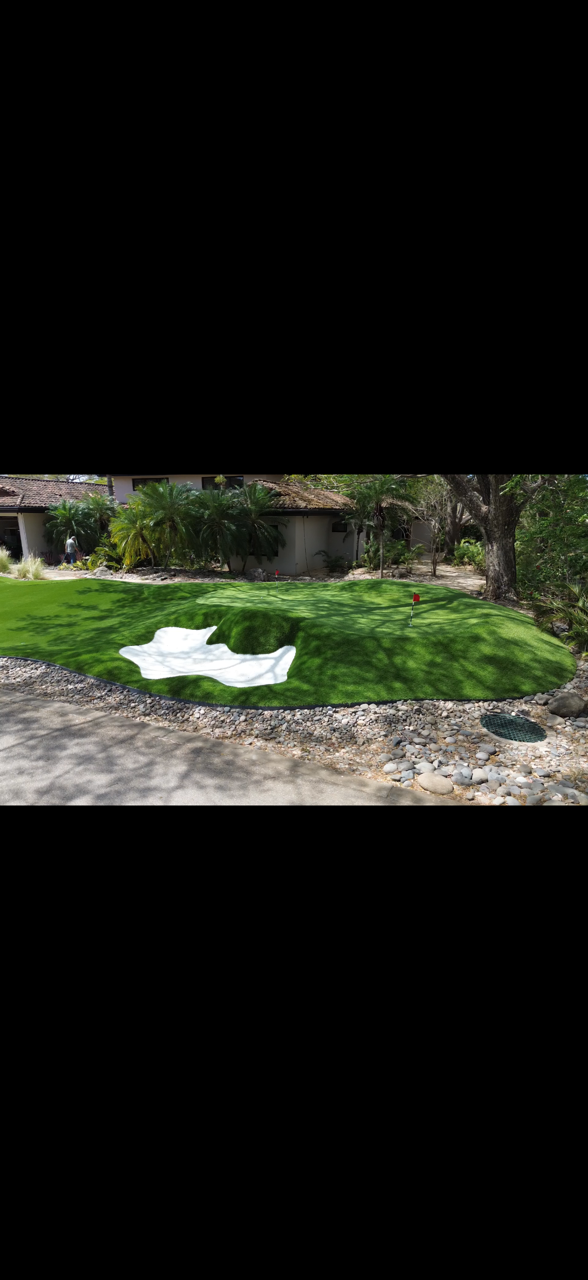 Luxury Backyard Putting Green With Sand Bunker Feature.