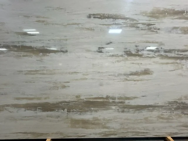 Close-up of a wooden surface with a weathered, distressed finish in shades of white, gray, and beige.