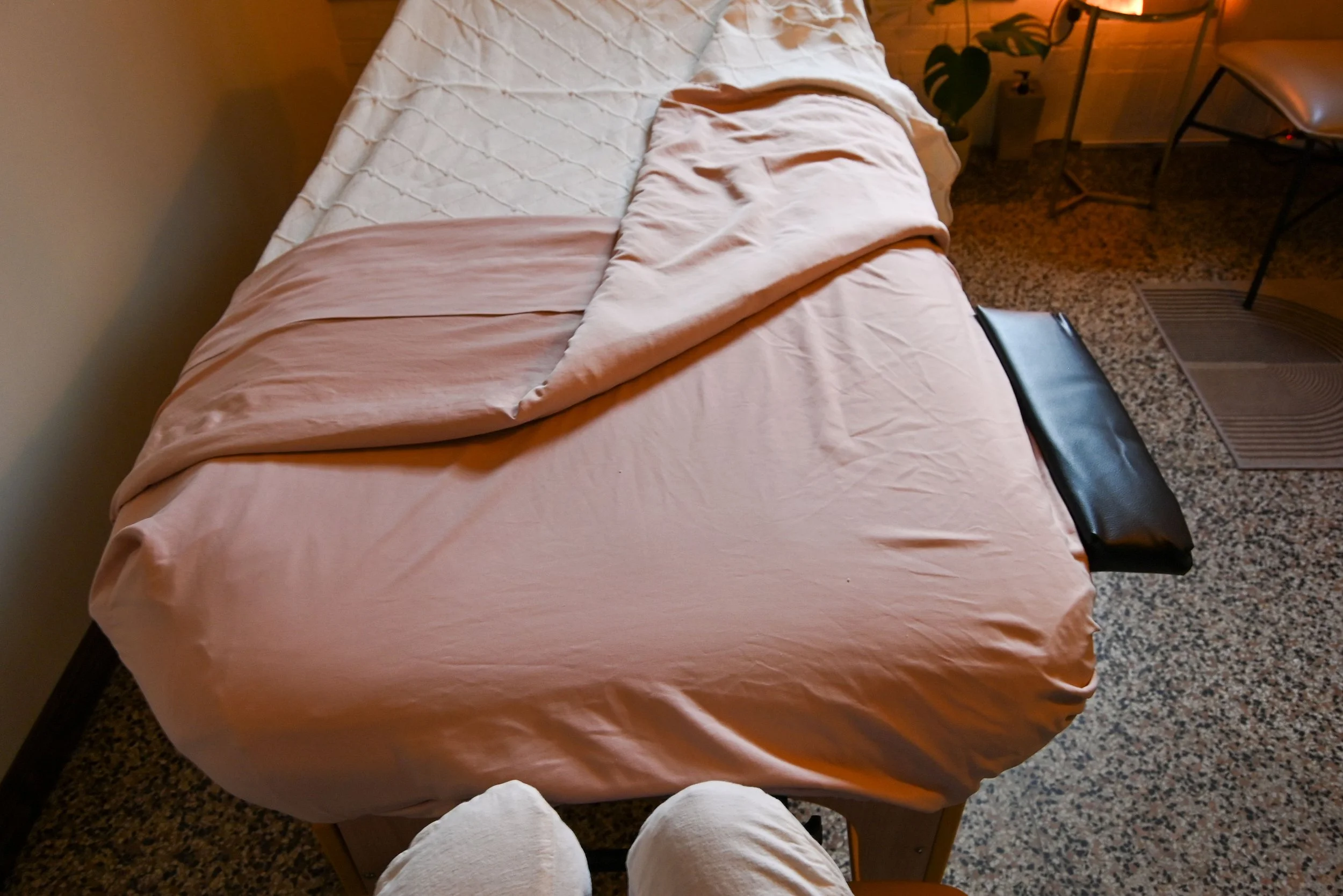 TREATMENT ROOM: Massage table with extendable arm wings.