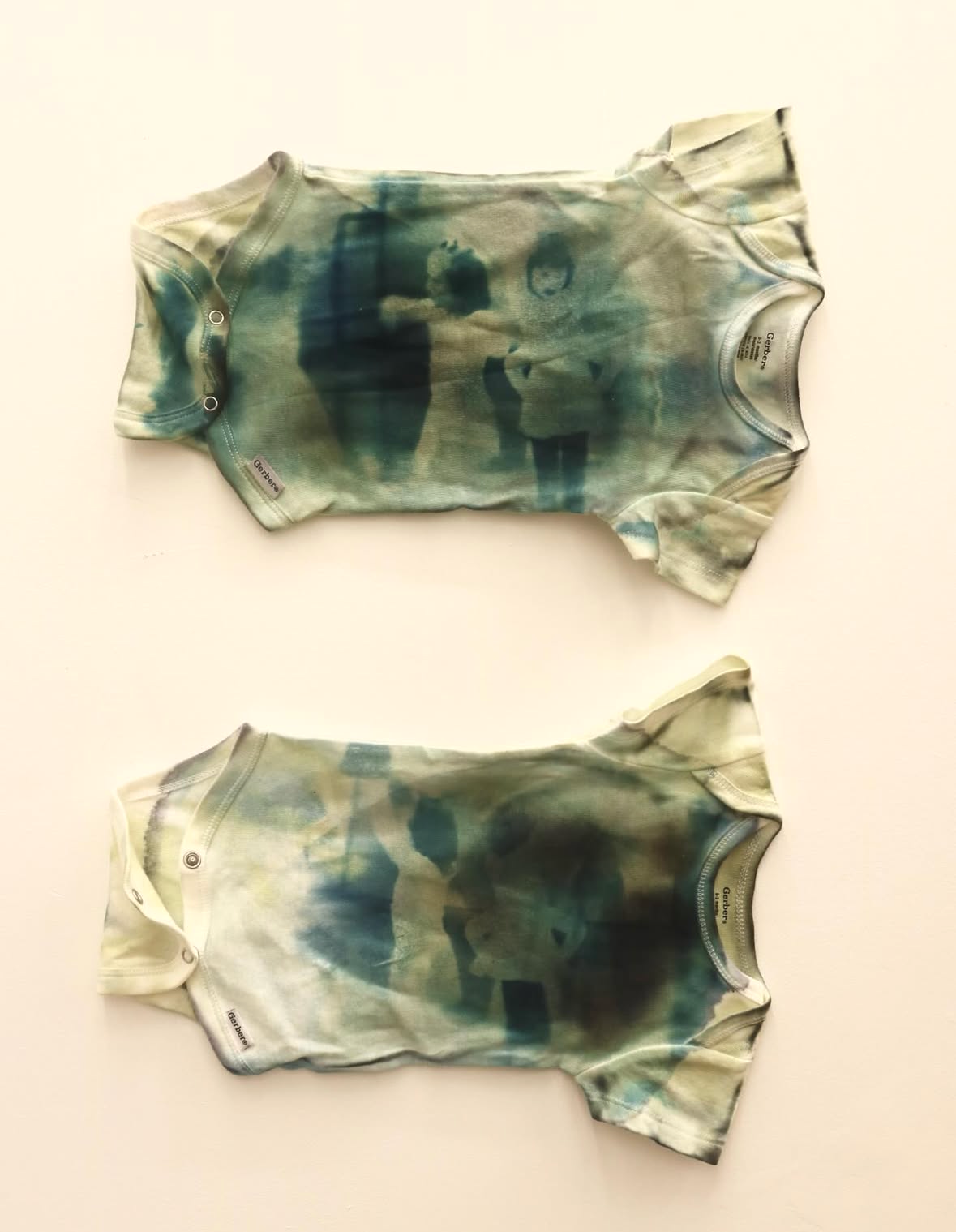 untitled (2025) Dimensions vary, Cotton baby clothes, Cyanotype, Loose pigment 