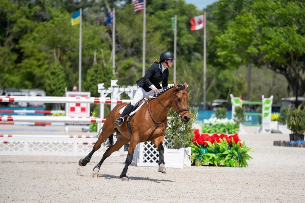 Bryn Sadler riding Catch the Dollar galloping away from a jump at HITS Ocala, Florida
