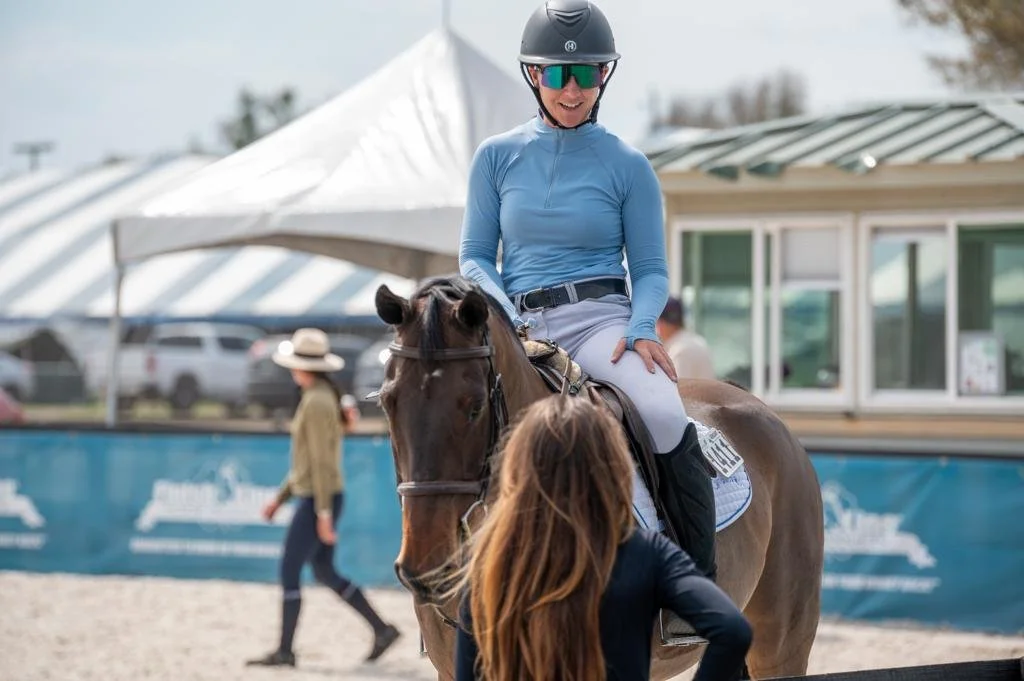 Bryn Sadler riding Cezarro at the in-gate reviewing the course at a horse show with GS Equestrian