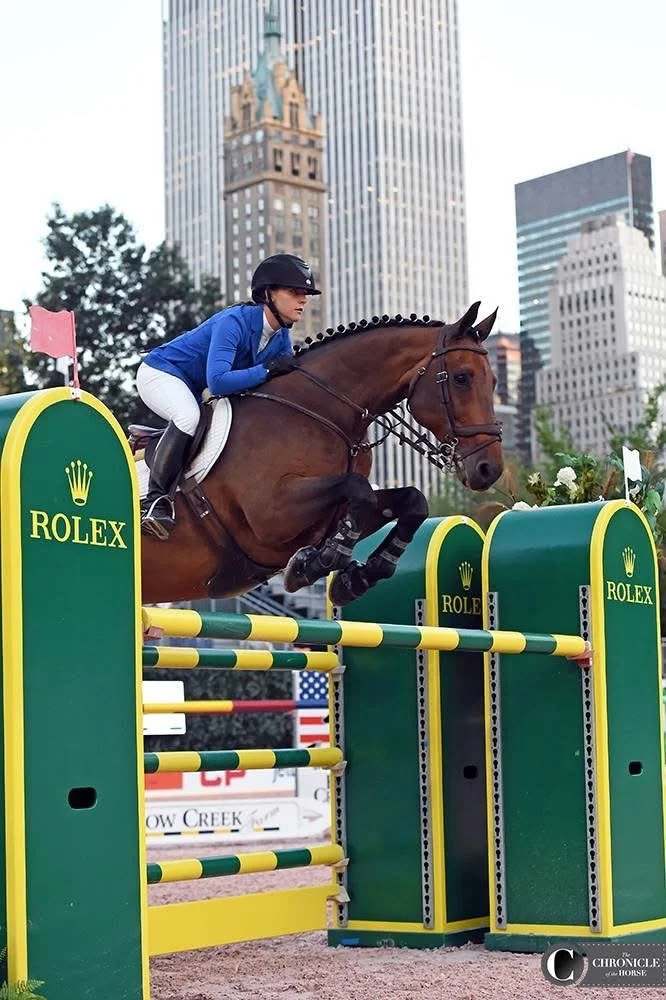 Bryn Sadler riding Bon Giorno at the Central Park Horse Show in New York City with skyscrapers in the background