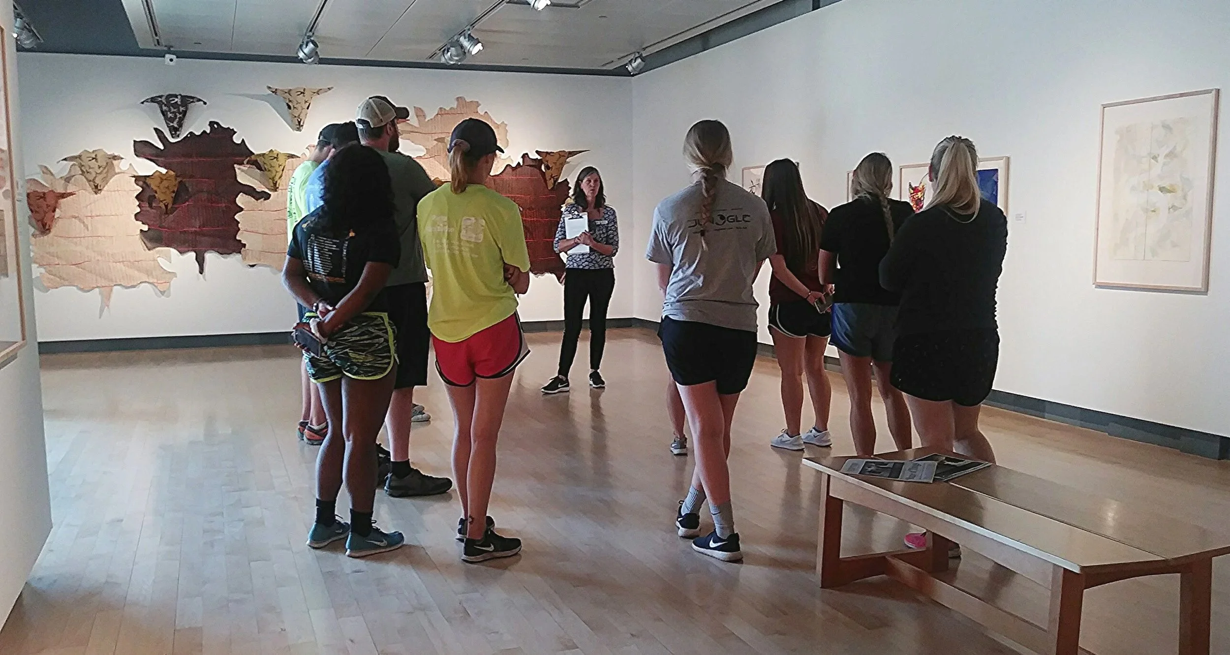 A MAM docent leads a group of visitors on a tour of the exhibition.