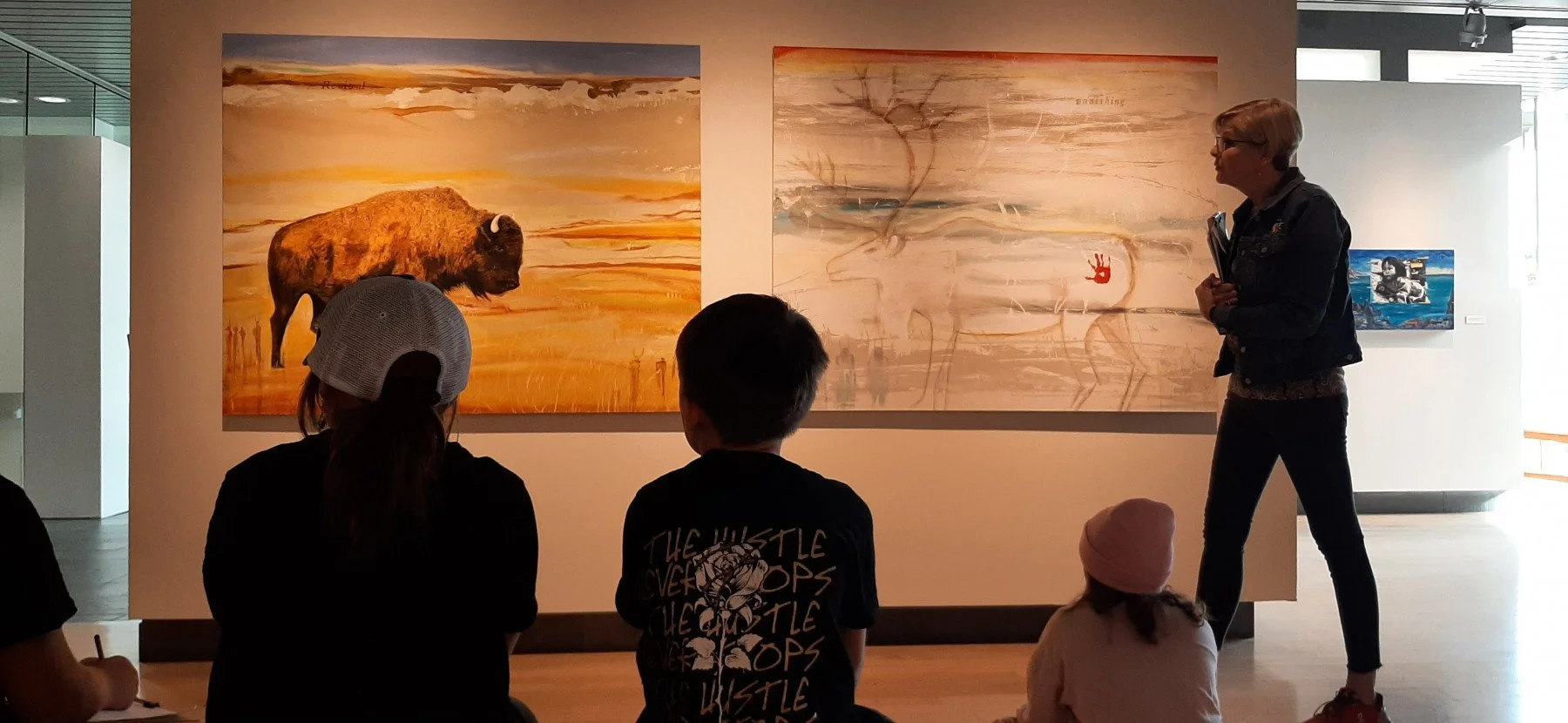 A Missoula Art Museum docent leads a guided tour of Alaina Buffalo Spirit's exhibition during the Fifth Grade Art Experience.