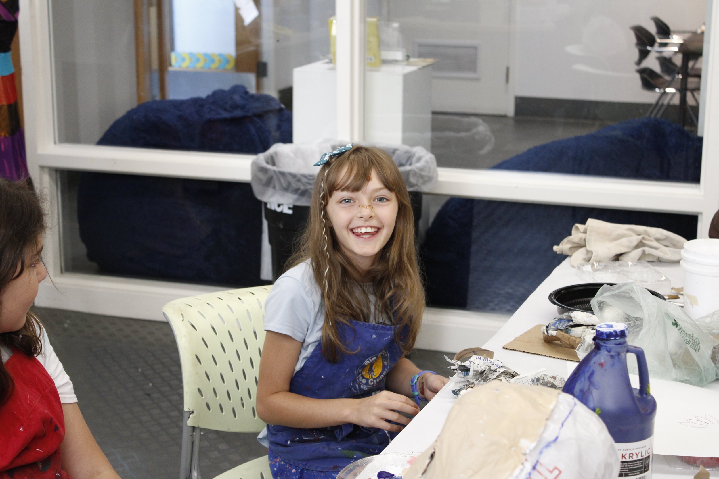 A student smiles at the camera during a MAM summer camp.