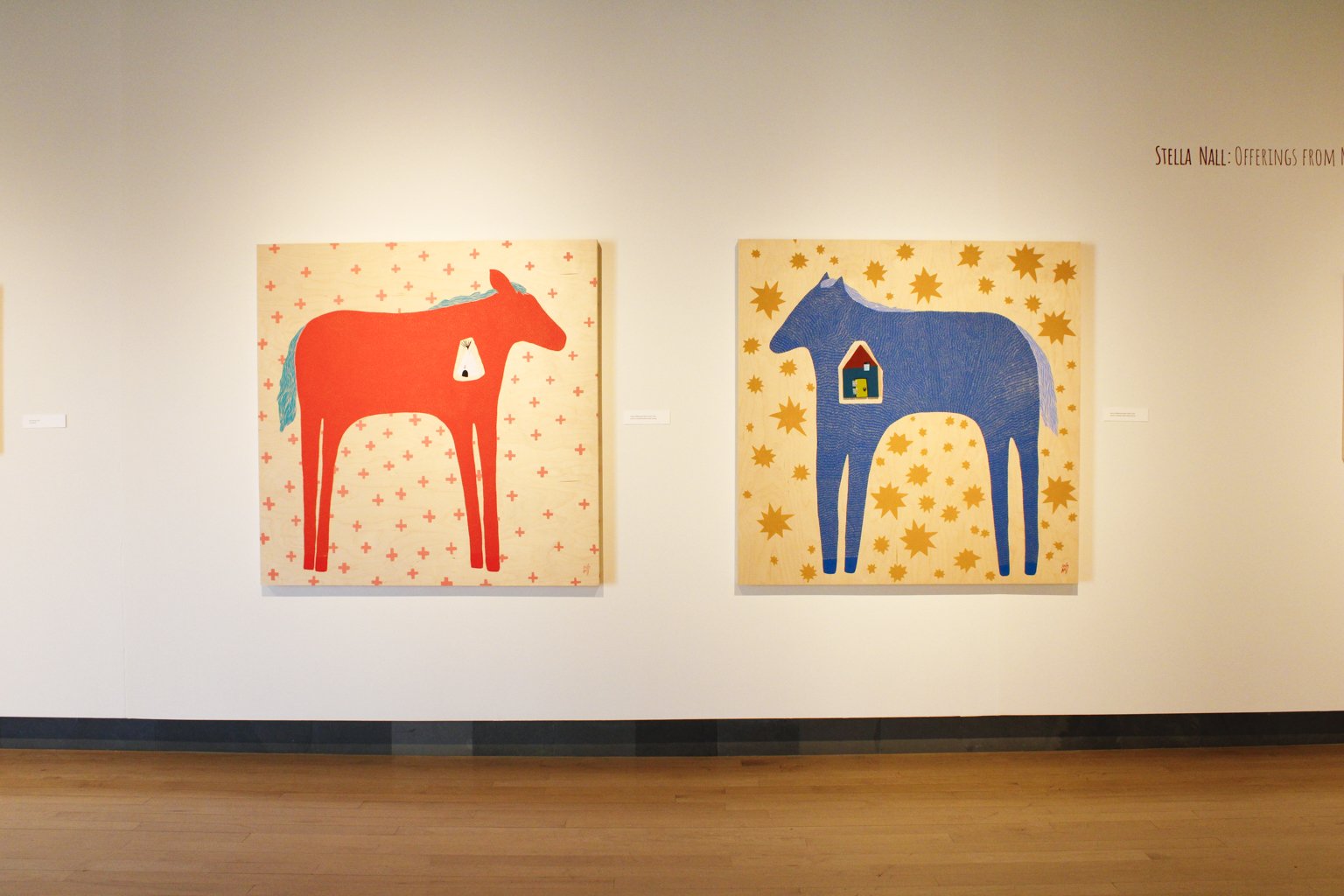 Image of an orange horse and blue horse by exhibiting artist Stella Nall