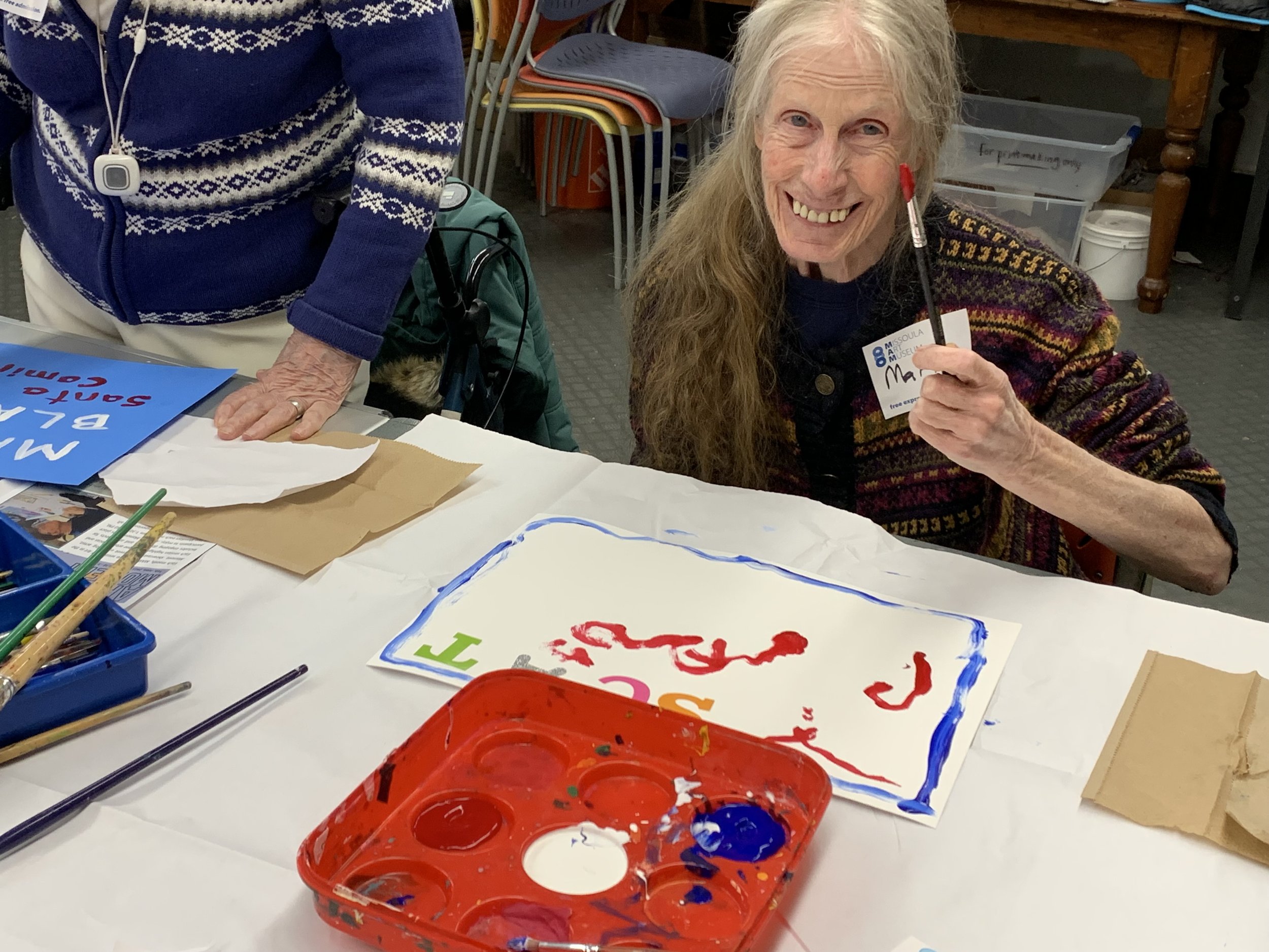 Close-up of gold-painted carved wooden sculptures and fragments, possibly part of traditional or ceremonial artifacts, arranged on a table.