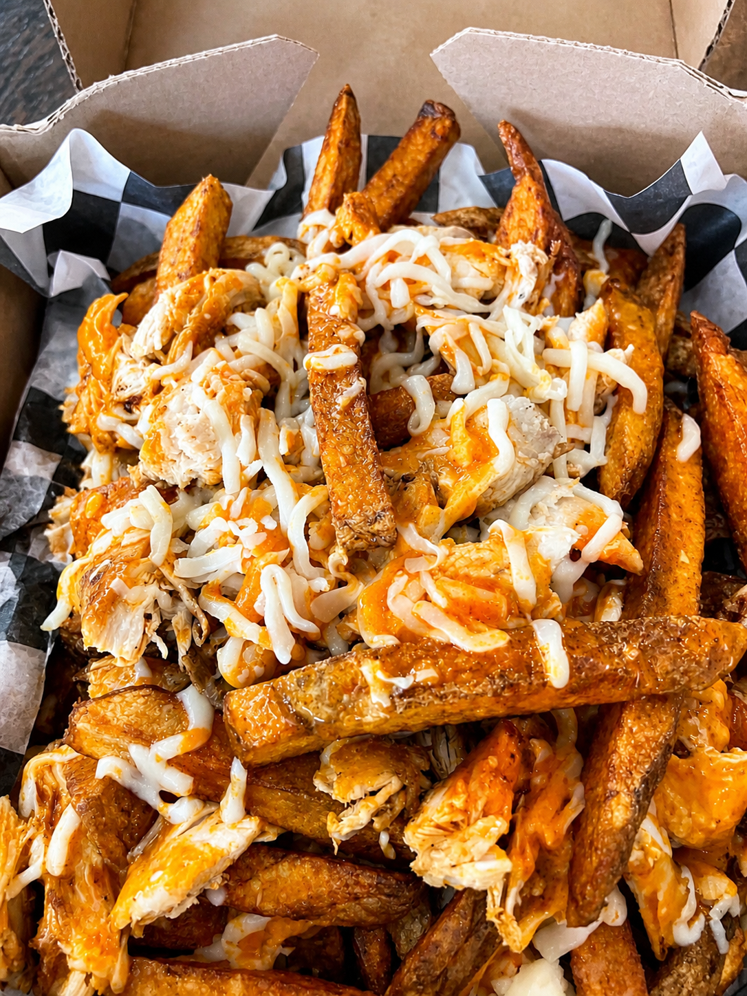Loaded Finn fries topped with rotisserie chicken, melted mozzarella, and buffalo sauce in Lockport NY