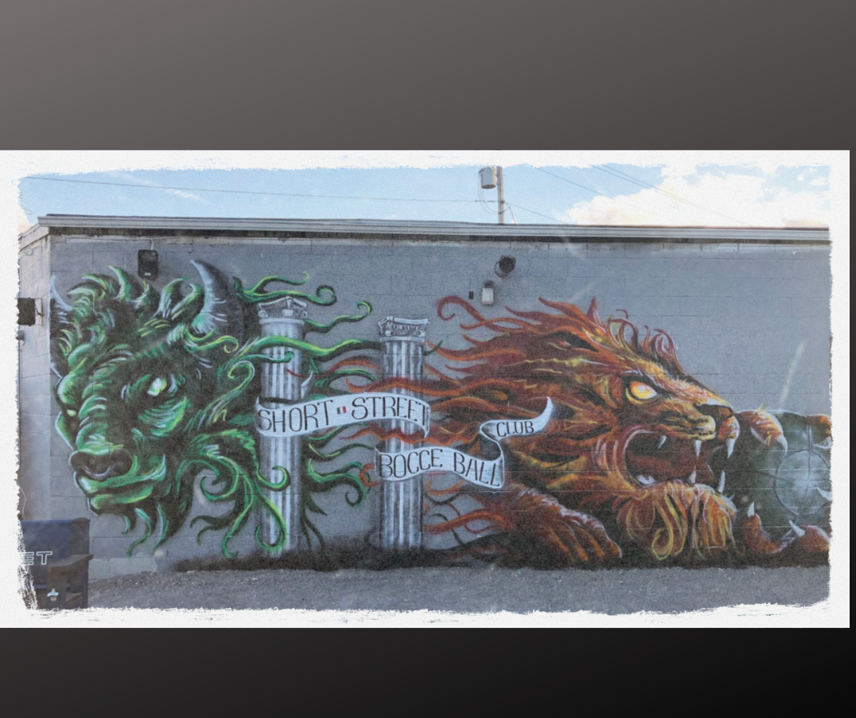Graffiti mural featuring a green dragon on the left and a fierce orange lion on the right, with words 'Short  Street Bocce Ball Club' written on banners across the scene.