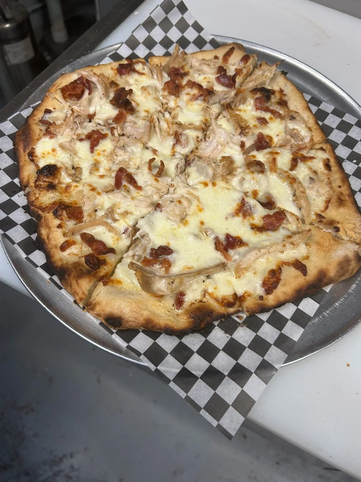 Chicken bacon ranch pizza topped with rotisserie chicken, crispy bacon, mozzarella, and ranch in Lockport NY