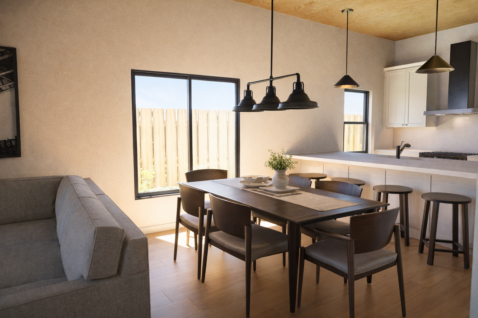 Open kitchen and dining area with shared layout and large windows.
